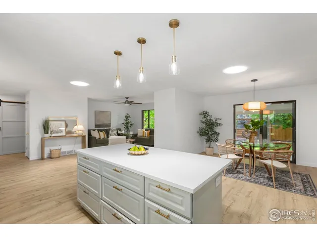 a kitchen with a table chairs and white cabinets