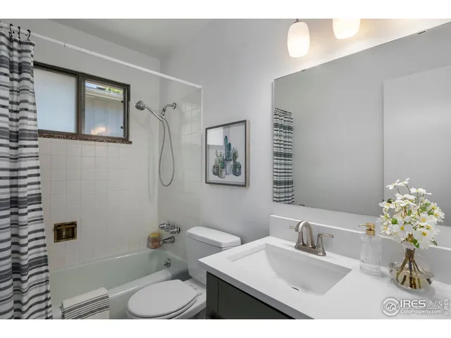 a bathroom with a sink vanity granite tub and shower