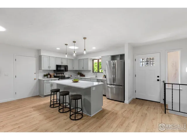 a kitchen with a refrigerator and a sink