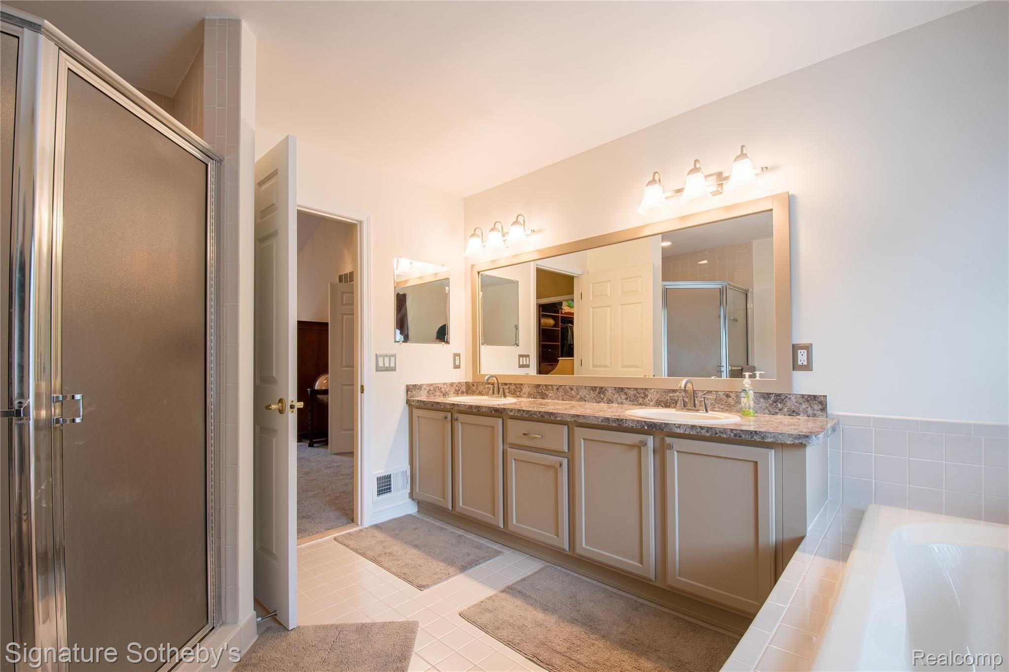 745 West Ridge Court Lake Orion, MI 48359 - Photo 25 of 44 Master bathroom with dual sinks, tub & shower