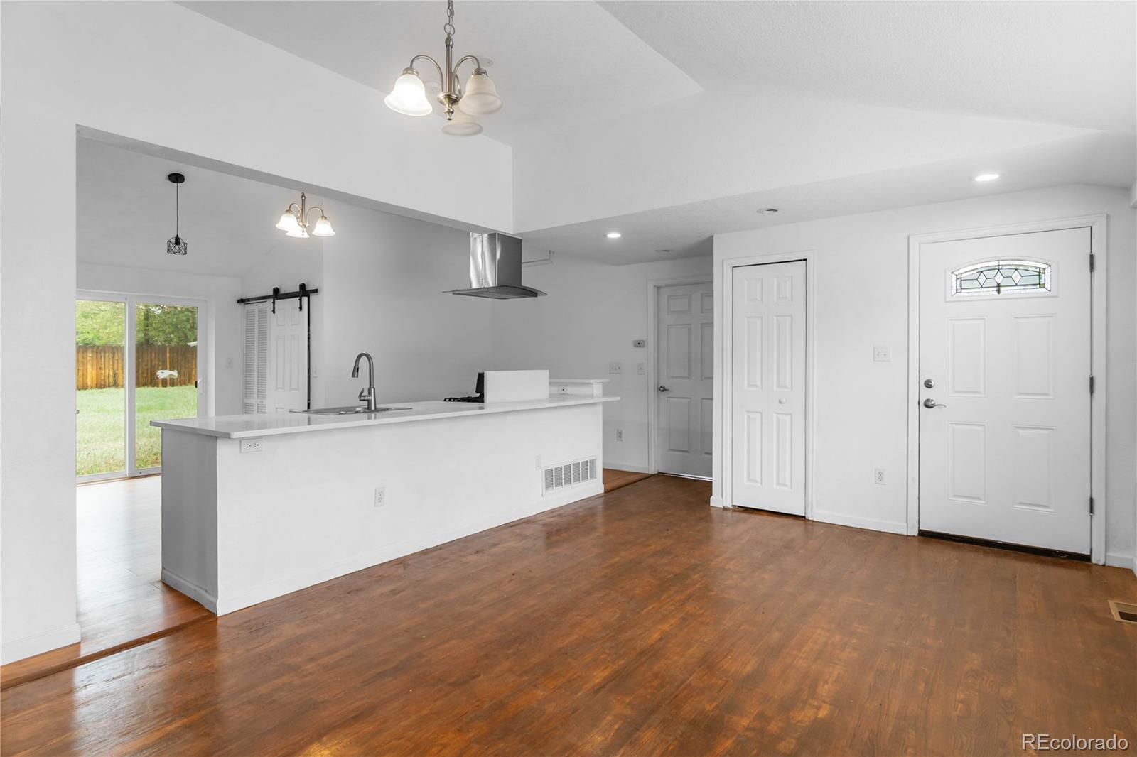 7010 West 44th Avenue Wheat Ridge, CO 80033 - Photo 5 of 31 a view of kitchen with wooden floor and window