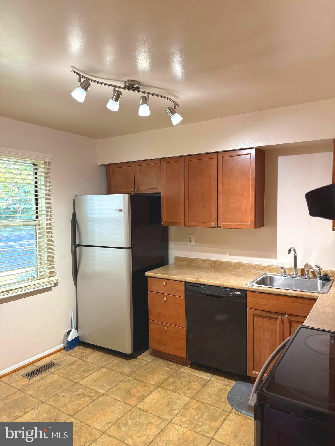 7028 Palamar Turn Lanham, MD 20706 - Photo 14 of 44 a kitchen that has a sink stainless steel appliances a counter space and a window