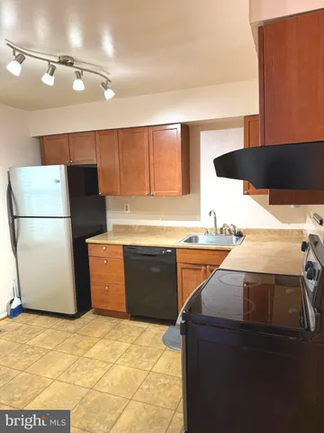 a kitchen with a refrigerator and a stove