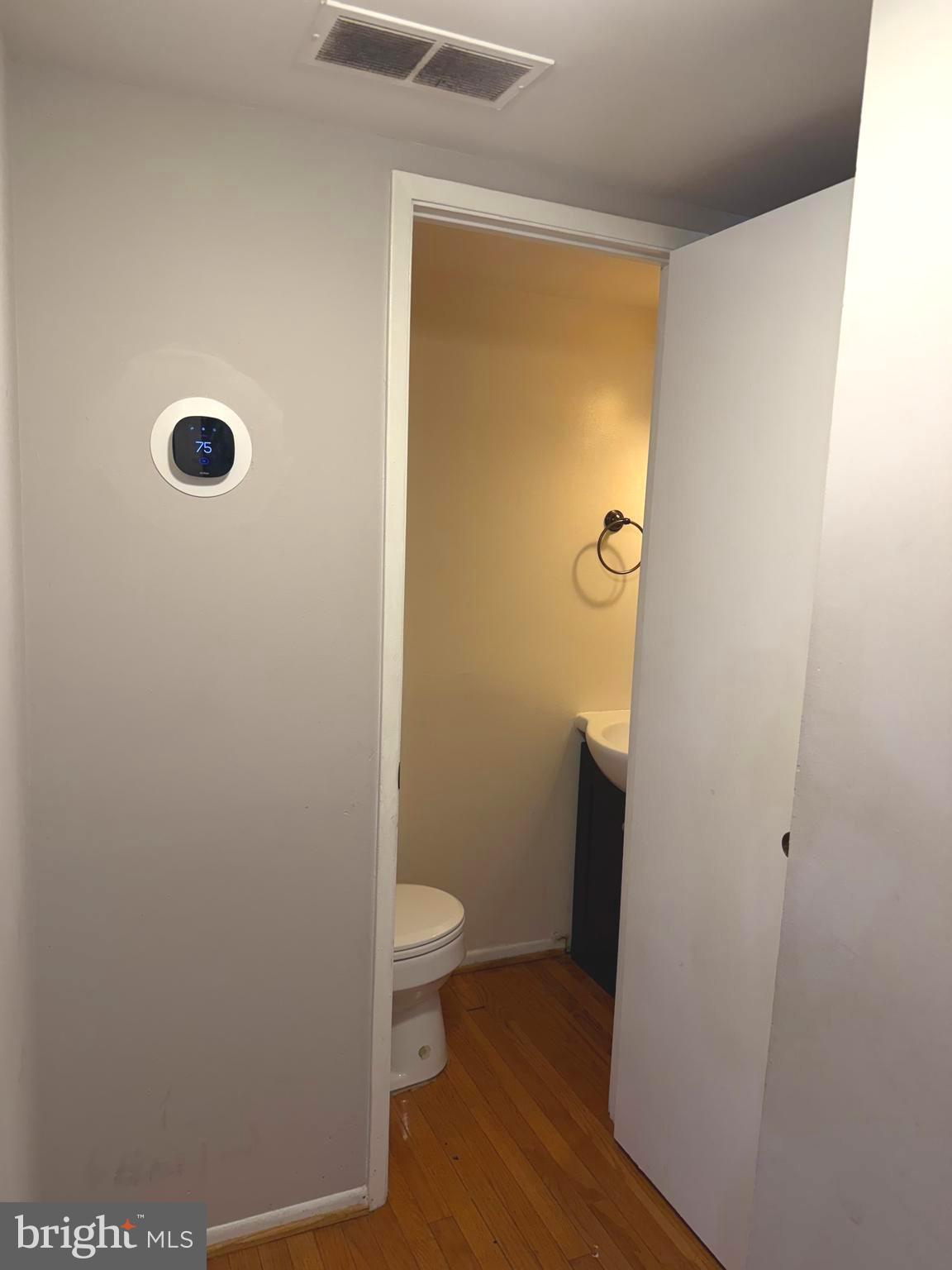 7028 Palamar Turn Lanham, MD 20706 - Photo 19 of 44 a bathroom with a granite countertop toilet and a sink