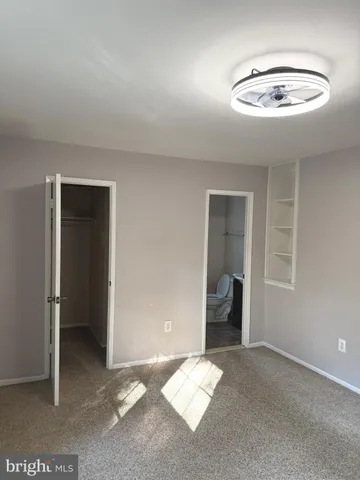 a view of a livingroom with wooden floor and a chandelier