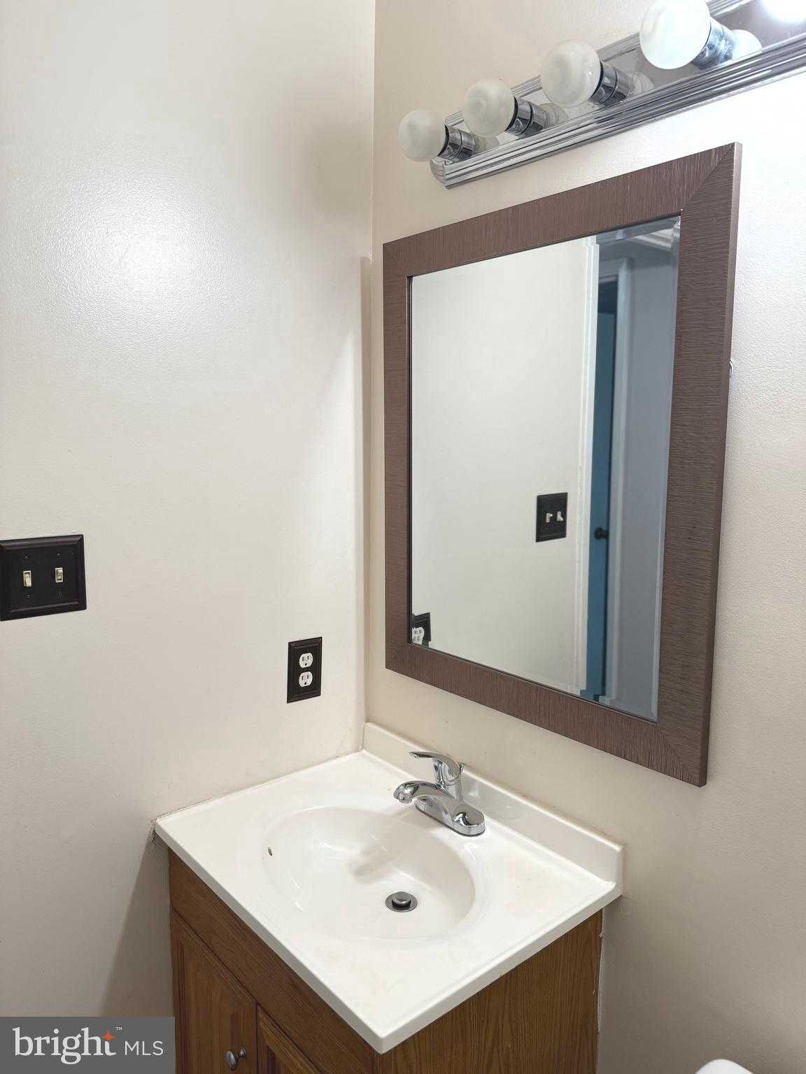 7028 Palamar Turn Lanham, MD 20706 - Photo 30 of 44 a bathroom with a sink and a mirror