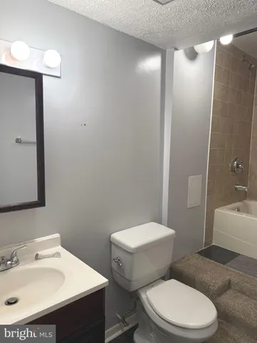 a white toilet sitting next to a bathroom sink