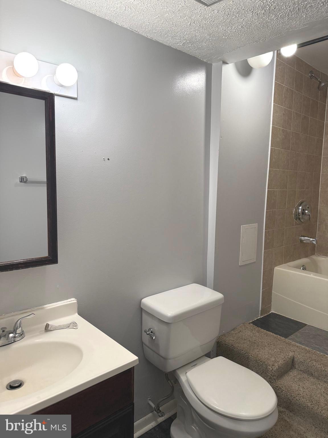 7028 Palamar Turn Lanham, MD 20706 - Photo 38 of 44 a white toilet sitting next to a bathroom sink