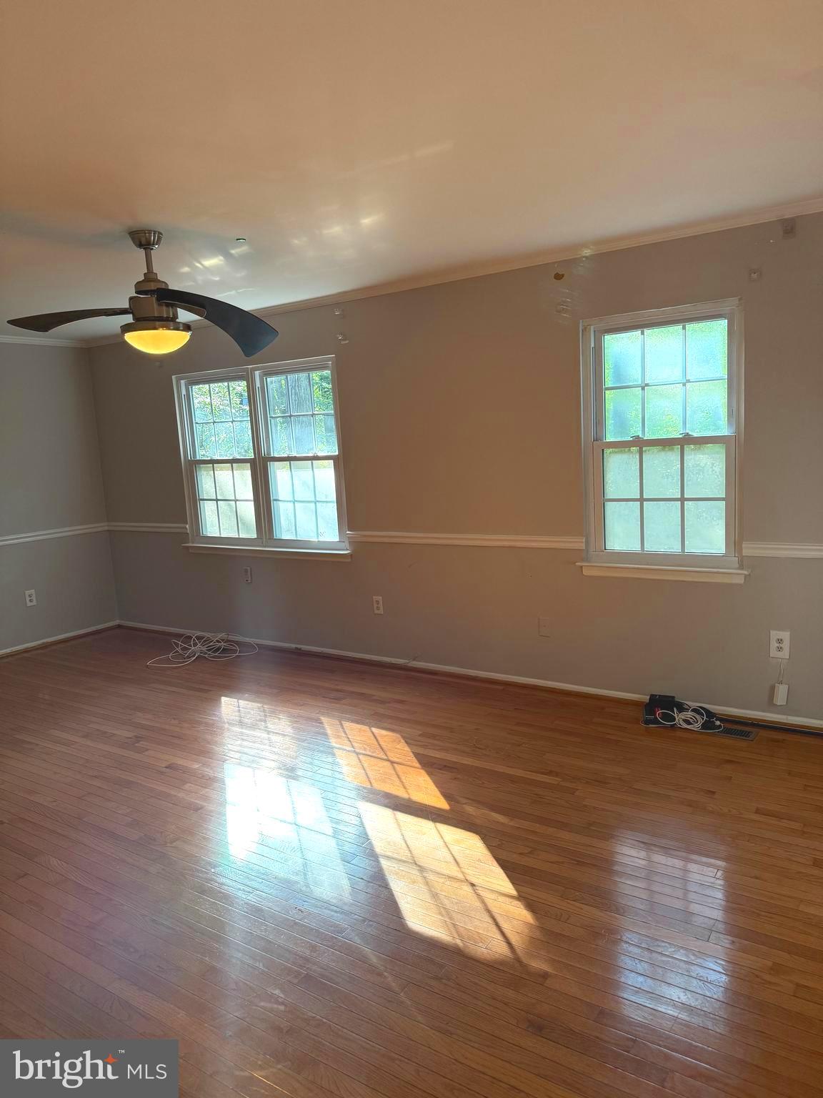 7028 Palamar Turn Lanham, MD 20706 - Photo 5 of 44 an empty room with wooden floor and windows
