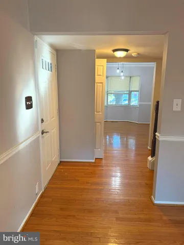 a view of livingroom with hardwood floor and front door