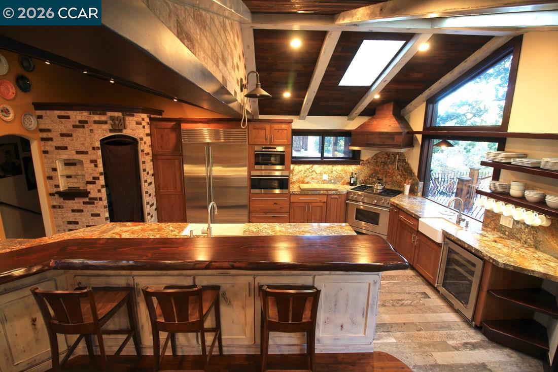321 Livorna Heights Road Alamo, CA 94507 - Photo 12 of 60 a kitchen with stainless steel appliances granite countertop a sink and wooden cabinets