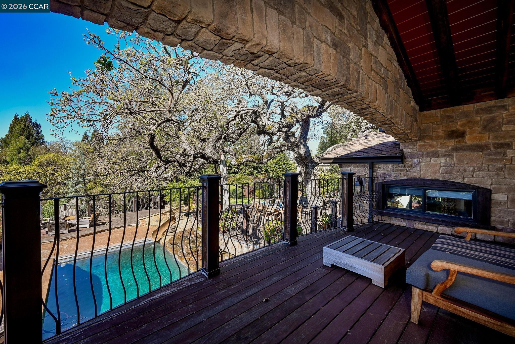 321 Livorna Heights Road Alamo, CA 94507 - Photo 23 of 60 a patio with wooden floor a yard a table and chairs