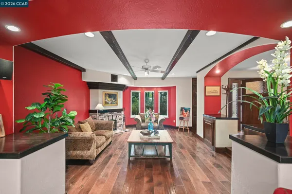 a living room with furniture and a floor to ceiling window