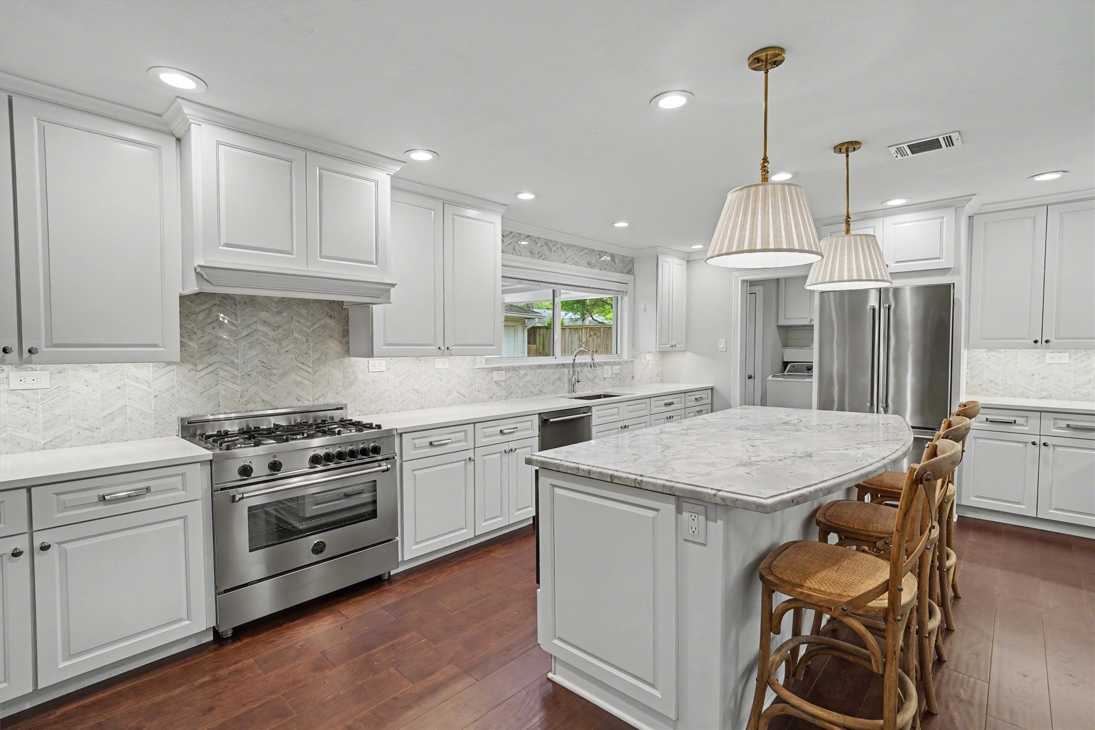 751 Bison Drive Houston, TX 77079 - Photo 12 of 45 a kitchen with a stove a sink a refrigerator and chairs