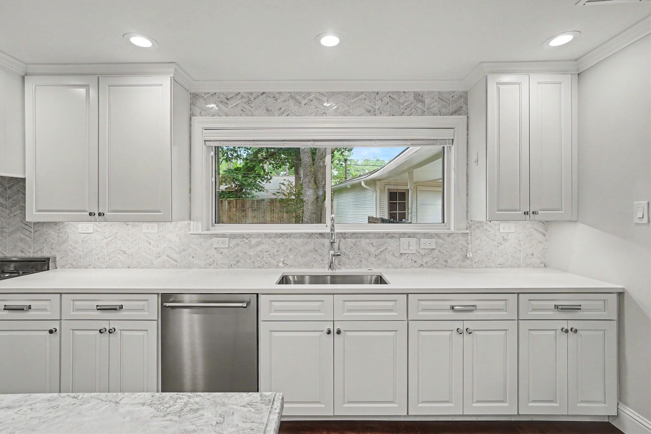 751 Bison Drive Houston, TX 77079 - Photo 13 of 45 a kitchen with white cabinets and sink