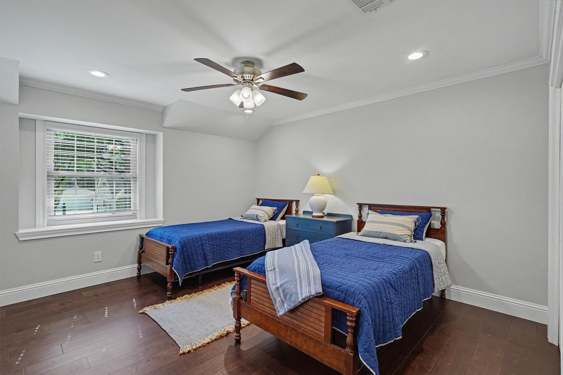 751 Bison Drive Houston, TX 77079 - Photo 24 of 45 a bedroom with two beds and a chandelier