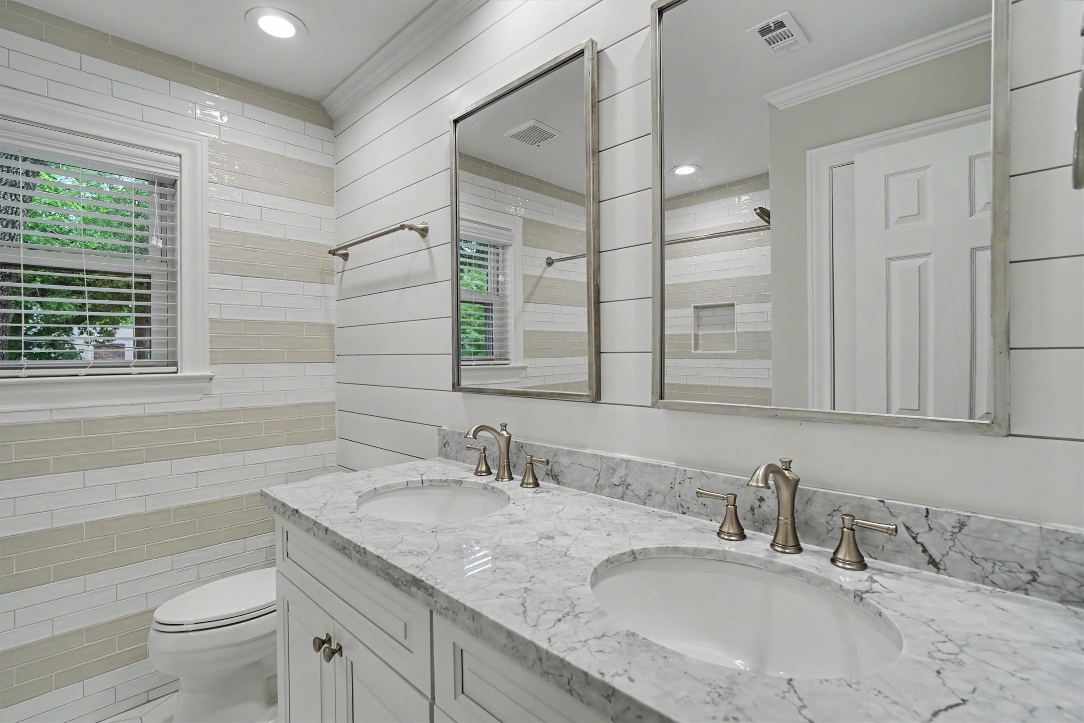 751 Bison Drive Houston, TX 77079 - Photo 26 of 45 a bathroom with double vanity sink a mirror and a bathtub