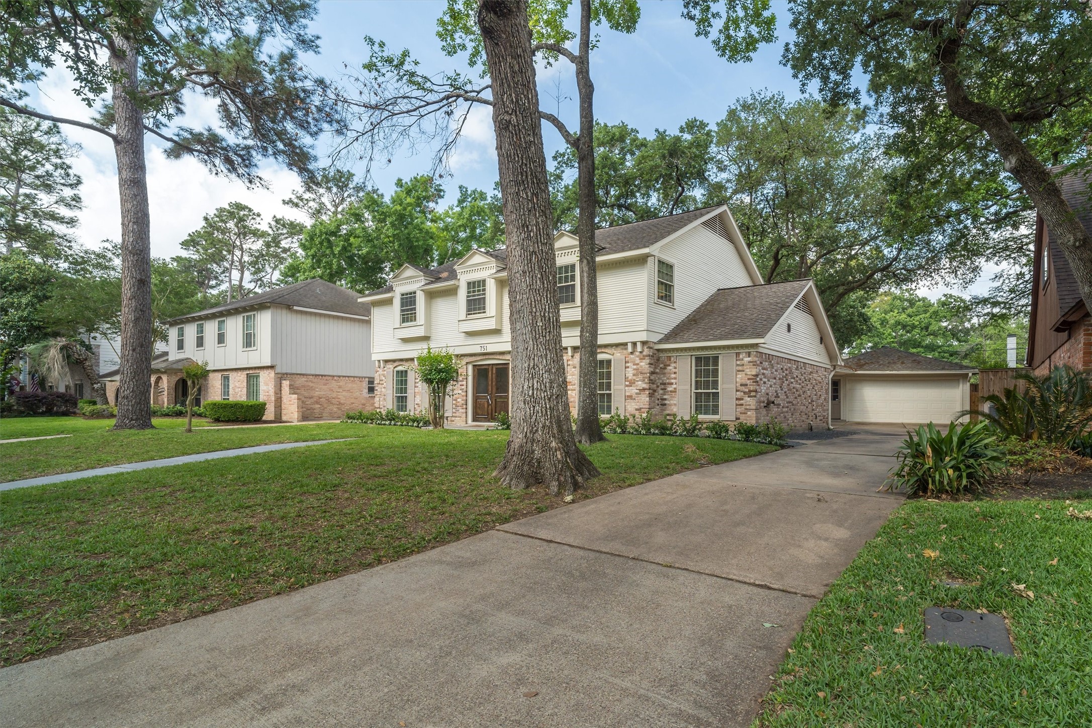 751 Bison Drive Houston, TX 77079 - Photo 36 of 45 a front view of a house with a yard and trees