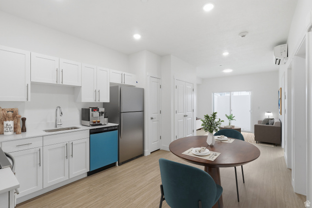2085 North Main Street, Unit 216 Sunset, UT 84015 - Photo 3 of 12 Kitchen and dining area featuring light wood-finish flooring