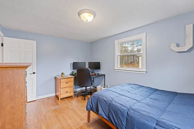 a bedroom with bed and a window