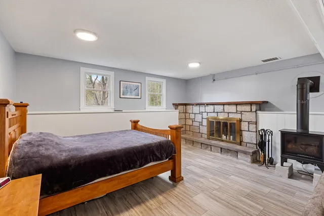 a bedroom with a bed furniture and a flat tv screen