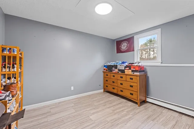 a view of room with hardwood floor and cabinet