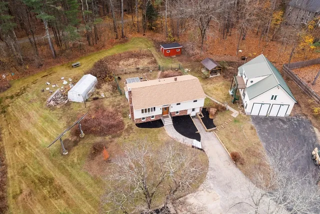 an aerial view of a house with a yard