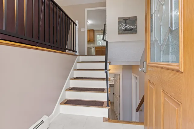 a view of entryway with wooden floor and windows