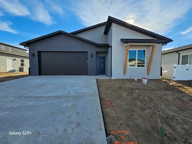 a front view of a house with yard and garage