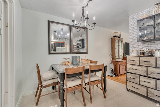 7470 Ramanee Drive Midvale, UT 84047 - Photo 11 of 29 Dining area featuring hanging lights and light tile patterned flooring