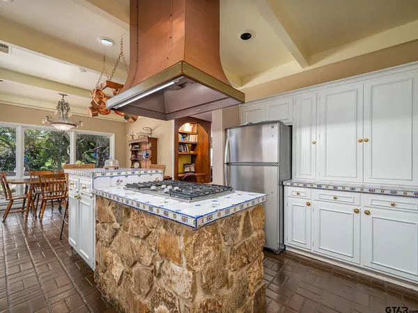 a kitchen with stainless steel appliances granite countertop a stove a sink and a refrigerator