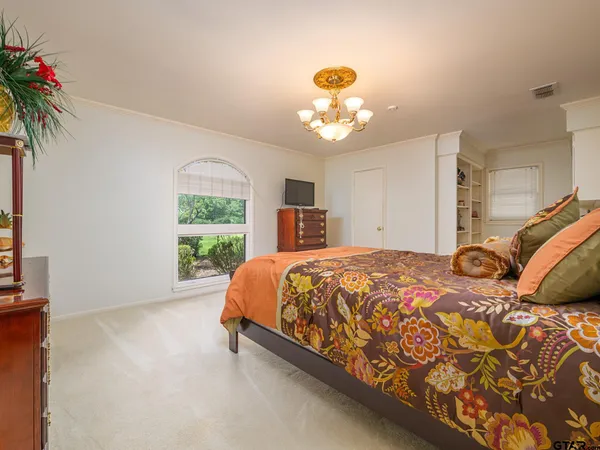 a bed sitting in a bedroom next to a window