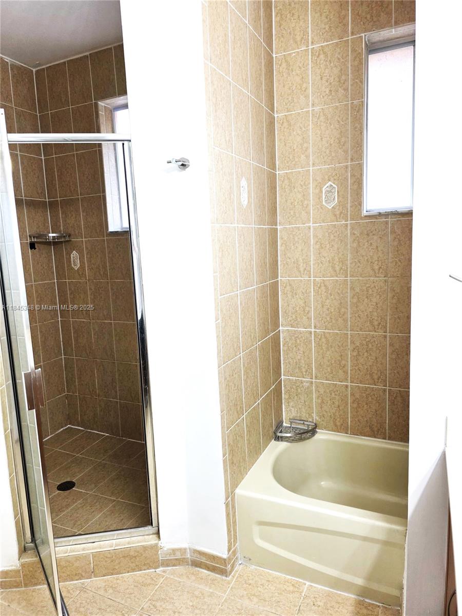 11357 Southwest 230th Terrace Miami, FL 33170 - Photo 14 of 24 a bathroom with a bathtub and a shower