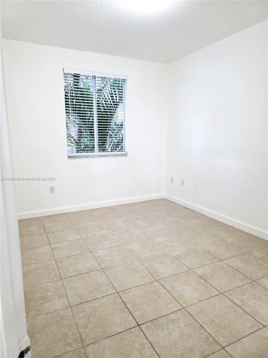 11357 Southwest 230th Terrace Miami, FL 33170 - Photo 19 of 24 an empty room with a window