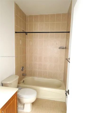 a large bathroom with a tub a sink and mirror