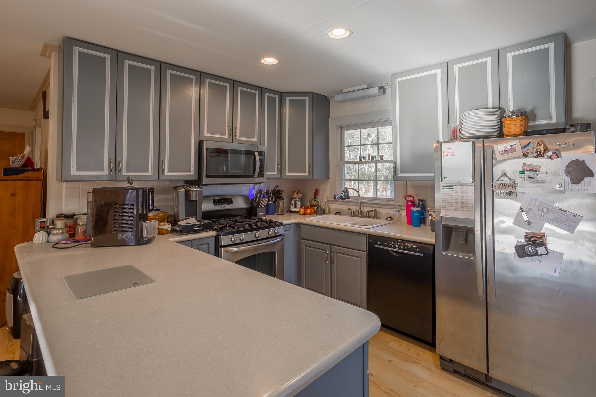 3819 Maple Dam Road Cambridge, MD 21613 - Photo 12 of 79 a kitchen with granite countertop a refrigerator stove top oven and sink