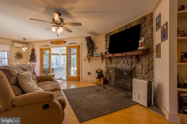 a living room with furniture and a floor to ceiling window