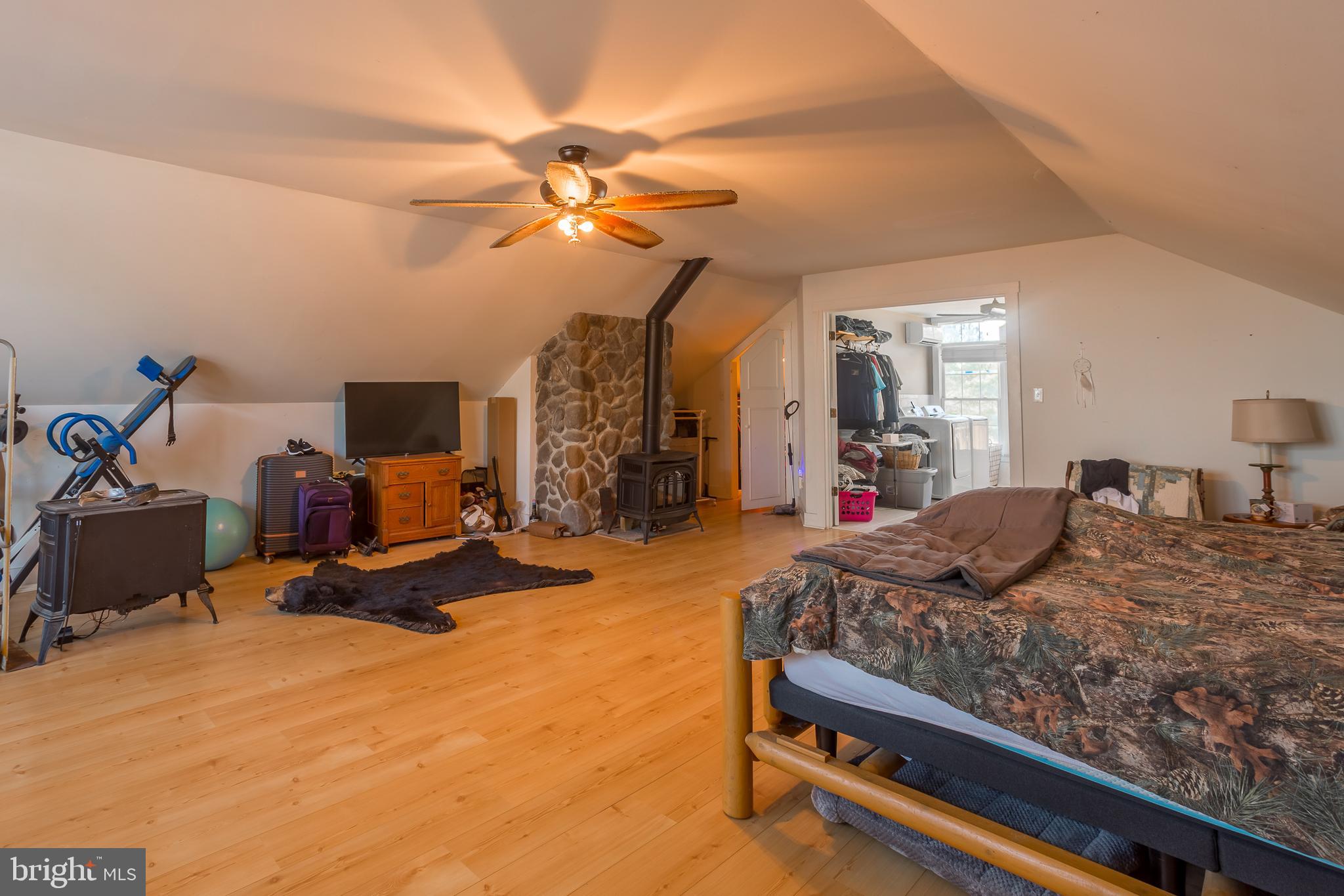 3819 Maple Dam Road Cambridge, MD 21613 - Photo 29 of 79 a bedroom with a bed and a chandelier
