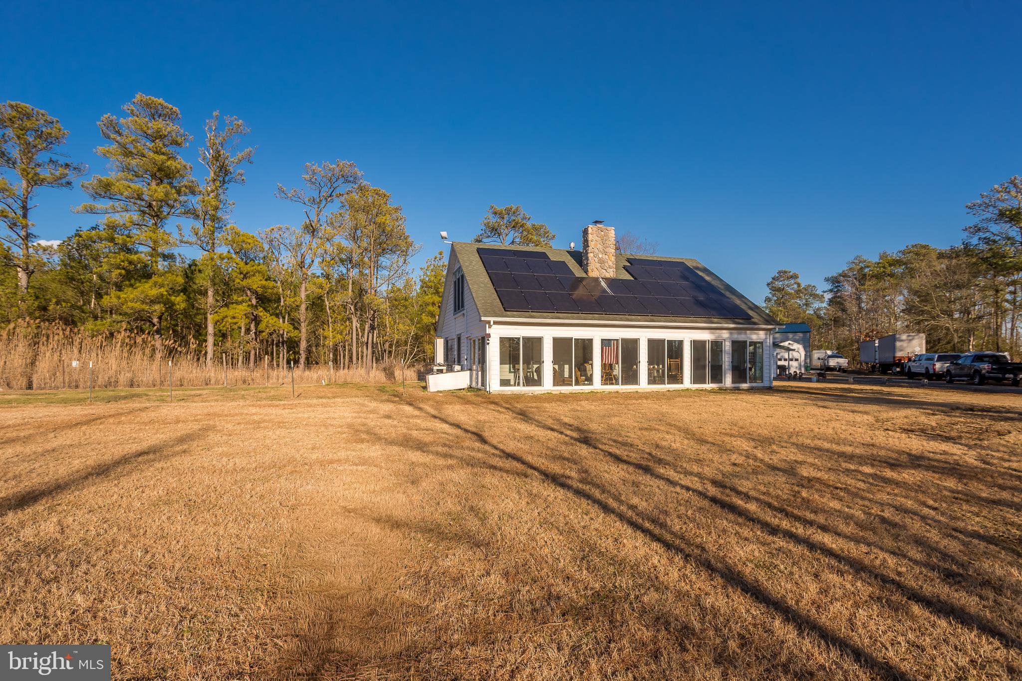 3819 Maple Dam Road Cambridge, MD 21613 - Photo 4 of 79 a front view of a house with a yard
