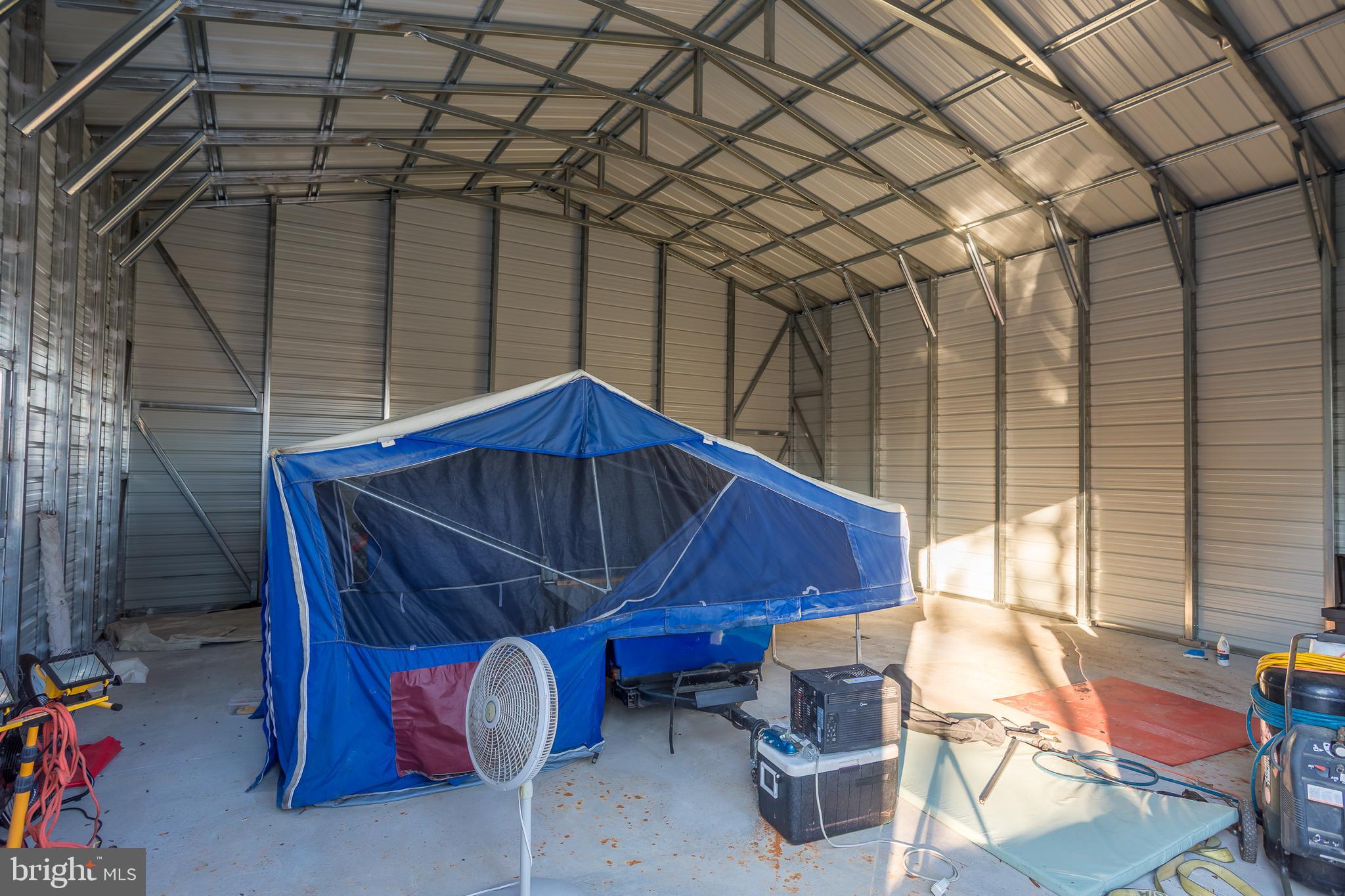 3819 Maple Dam Road Cambridge, MD 21613 - Photo 74 of 79 a blue and white umbrella sitting in a room next to a window