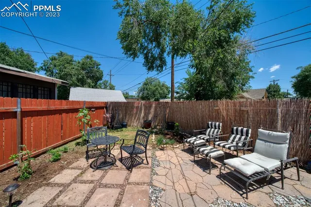 a view of a backyard with sitting area