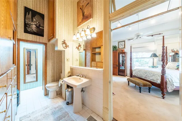 a living room with furniture and a painting on the wall