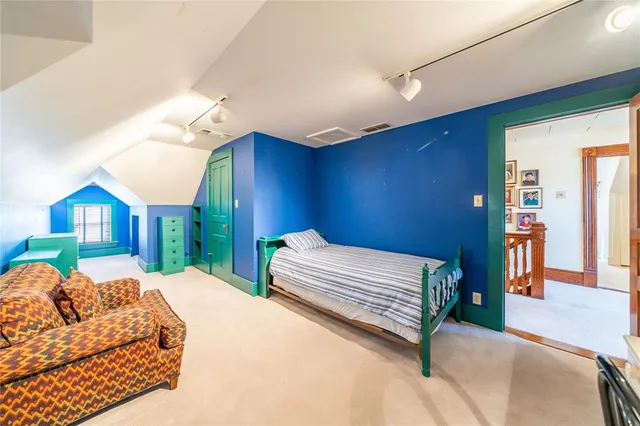 a bedroom with a bed couch and dresser