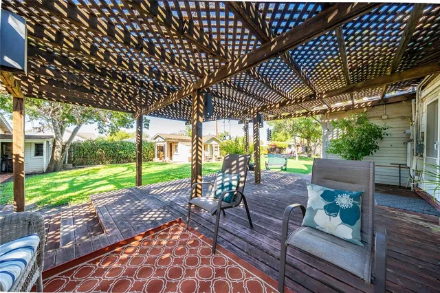 a view of a porch with wooden floor chairs and table