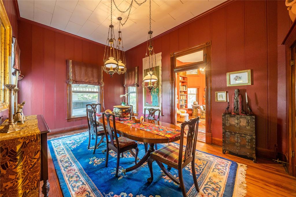 318 Northwest Ave A Hamlin, TX 79520 - Photo 7 of 23 a dining room with furniture a chandelier and wooden floor