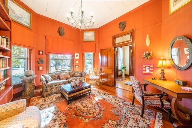 a living room with fireplace furniture and a large window