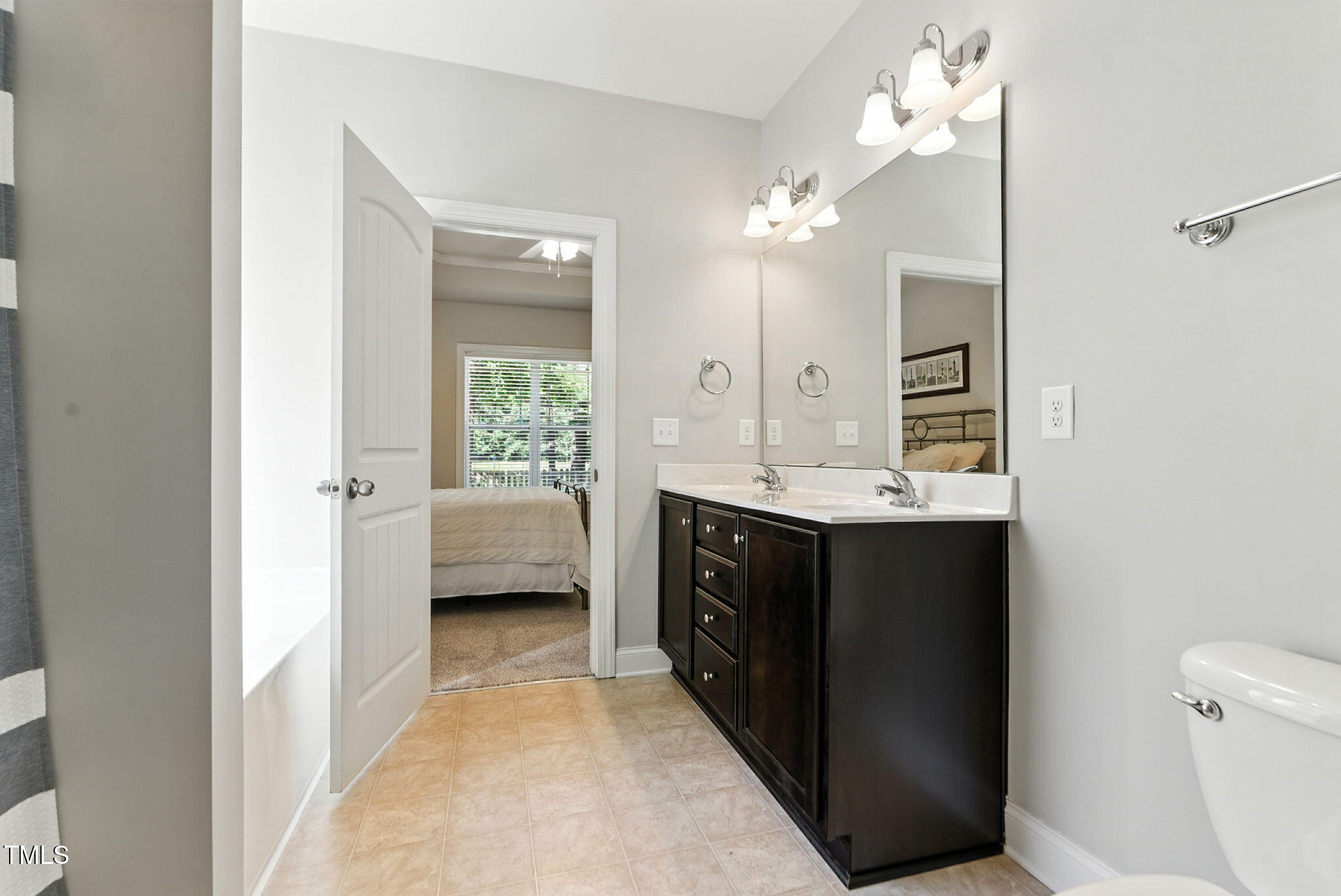 311 Coachmans Trail Stem, NC 27581 - Photo 15 of 27 a en suite bathroom with a sink a toilet and shower