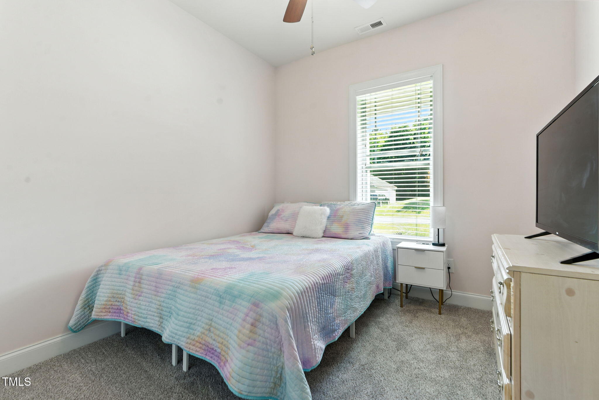 311 Coachmans Trail Stem, NC 27581 - Photo 18 of 27 a bedroom with a bed and a flat screen tv