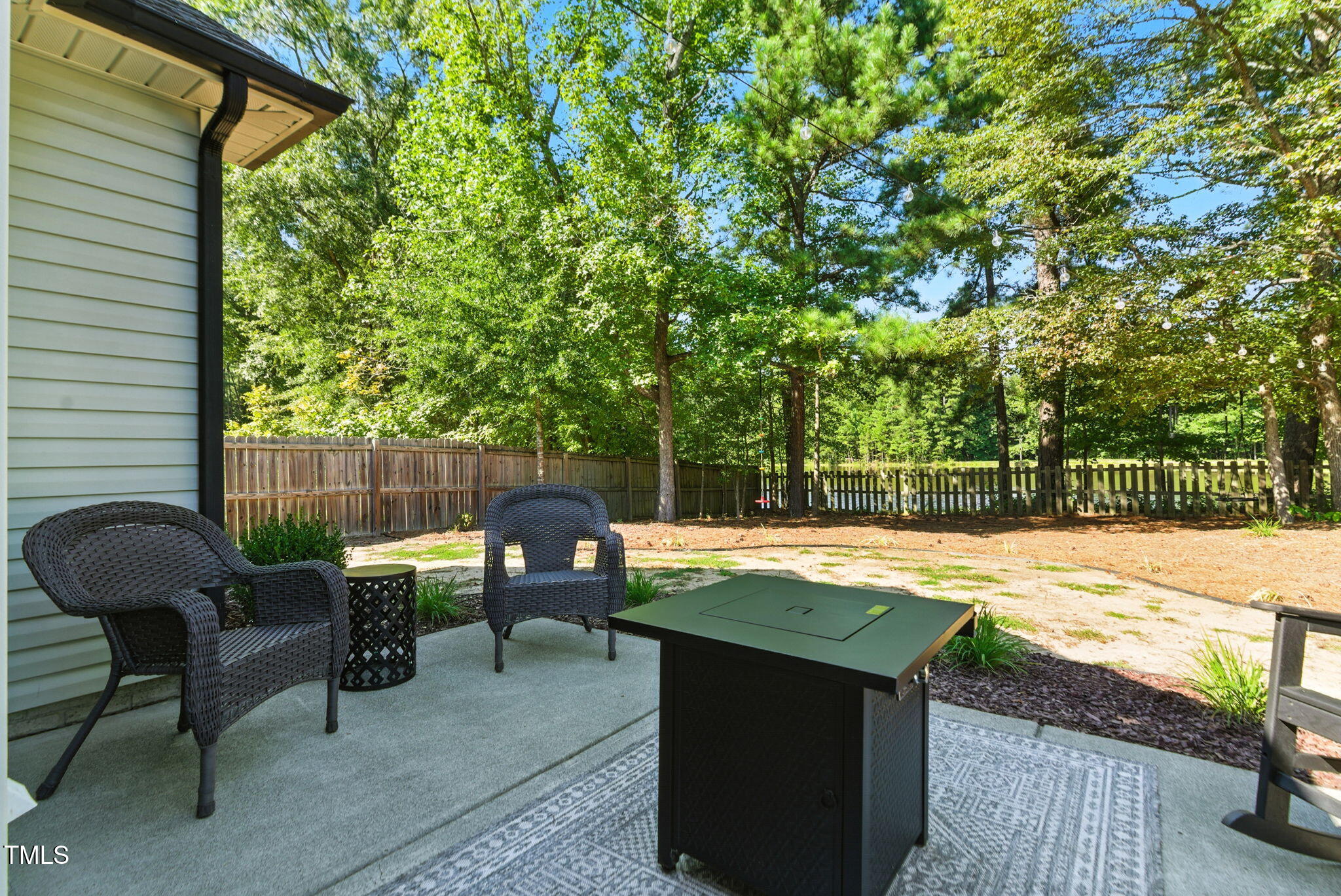 311 Coachmans Trail Stem, NC 27581 - Photo 20 of 27 a view of a backyard with sitting area and furniture