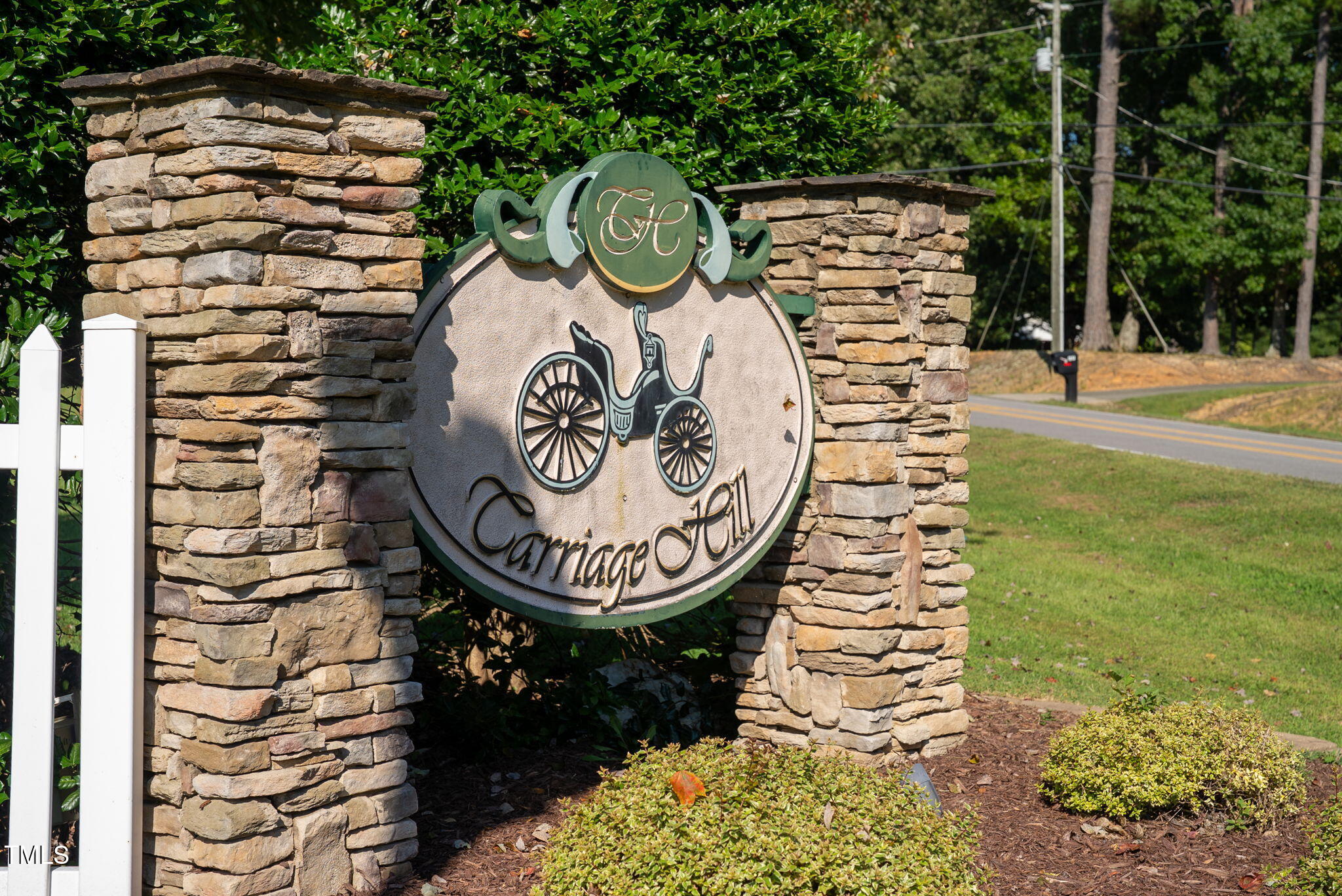 311 Coachmans Trail Stem, NC 27581 - Photo 27 of 27 a front view of a house with a garden
